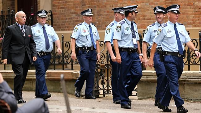 Police officers arrive for the trial for Fiona and Mitchell Barbieri charged with the murder of Inspector Bryson Anderson. They pleaded guilty to their roles in his death at the start of the trial this morning. Picture: John Grainger
