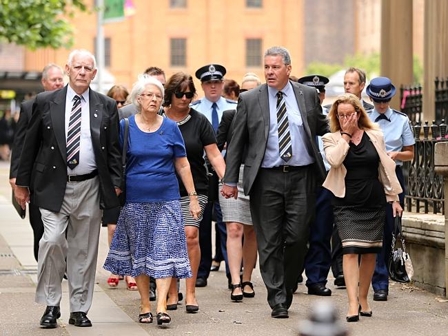 Family and friends of murdered Detective inspector Bryson Anderson and police head into the king st court complex. Picture: John Grainger