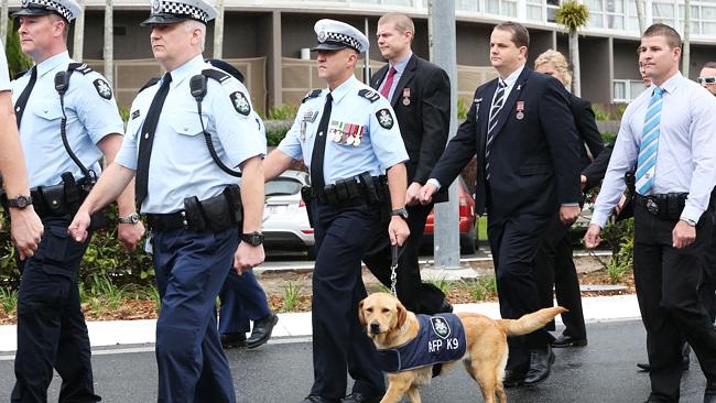 RESPECT: Cairns police march down the Esplanade and towards St John's Anglican church to mark National Police Remembrance Day. The Federal Police canine squad participated in the march. Picture: Brendan Radke.