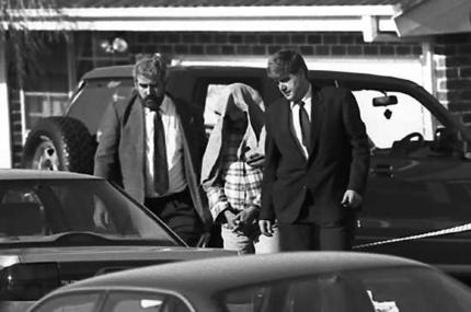 Homicide Detective Steve Leach, left, and another detective escort the backpacker killer Ivan Milat from his home in 1994. Photo: Rick Stevens