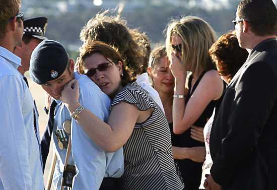 Friends of Adam Dunning after the hearse had left the tarmac. Photo: Andrew Taylor