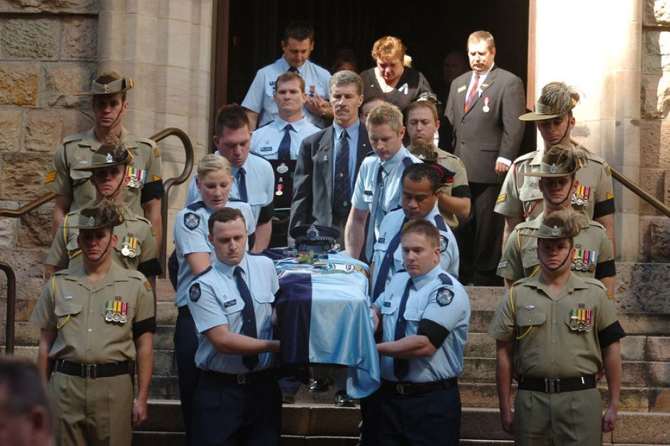 Collegues of Constable Brett Andrew Irwin carry his casket from the St Stephens Cathedral. Picture: AAP/Tony Phillips