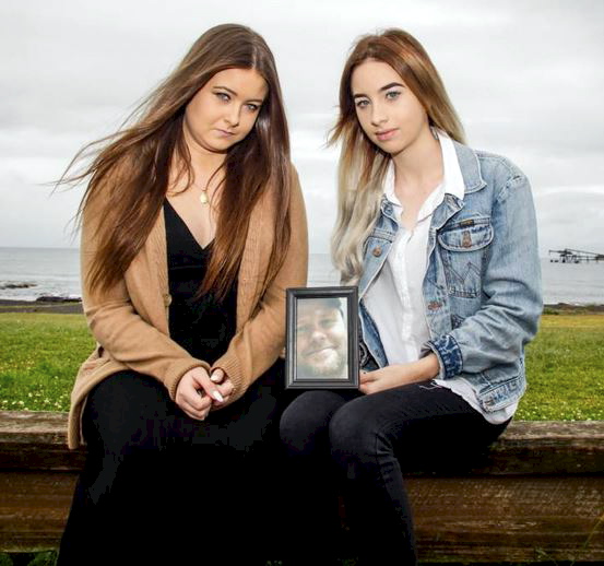 Sisters Maddison and Taylah McQuade with a picture of their father Leigh McQuade who recently committed suicide. Picture: Georgia Matts