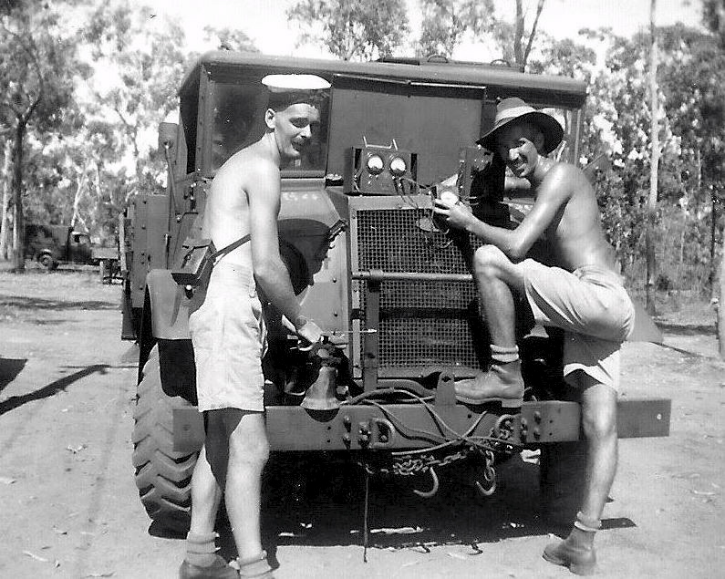 Copy write (From the private collection of William Jones) Craftsman Ivan Bedelph (TX13568) [Left] and Val McGuinness (TX12841) [right] testing the battery voltage on a CMP F15A truck at 39 Mile.