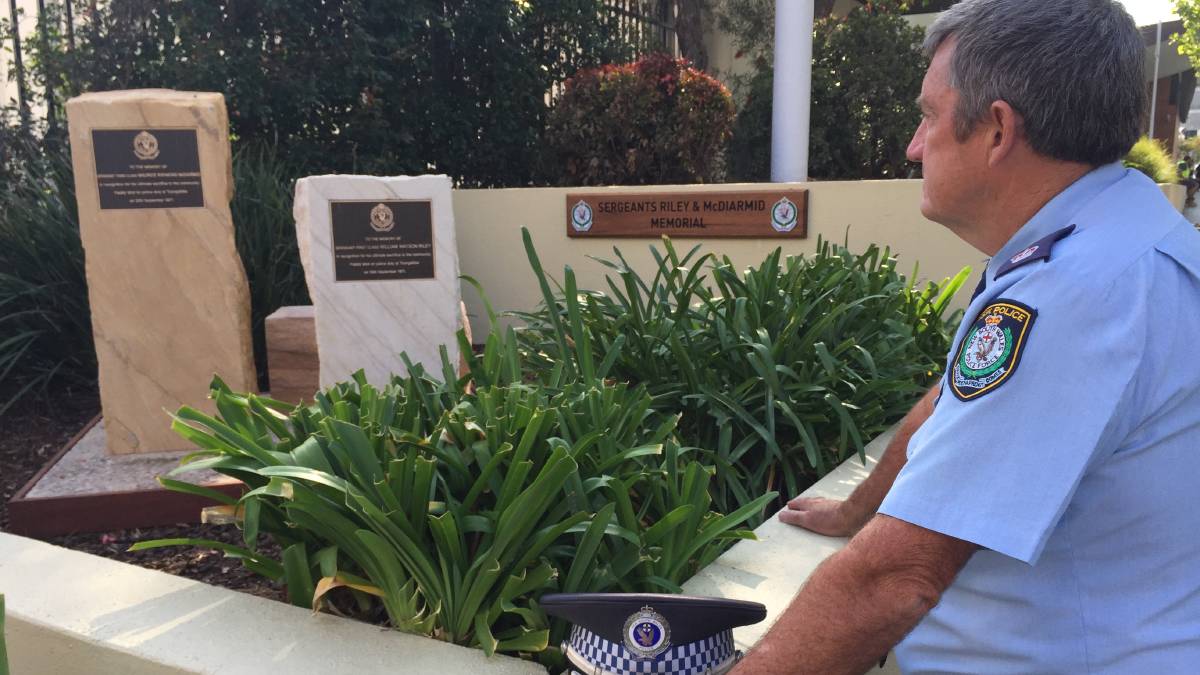 NOT FORGOTTEN: Blacktown Police Chief Inspector Bob Fitzgerald pays his respects at a memorial to slain officers Sergeant 1st Class William Riley and Sergeant 3rd Class Maurice McDiarmid. Picture: Harrison Vesey