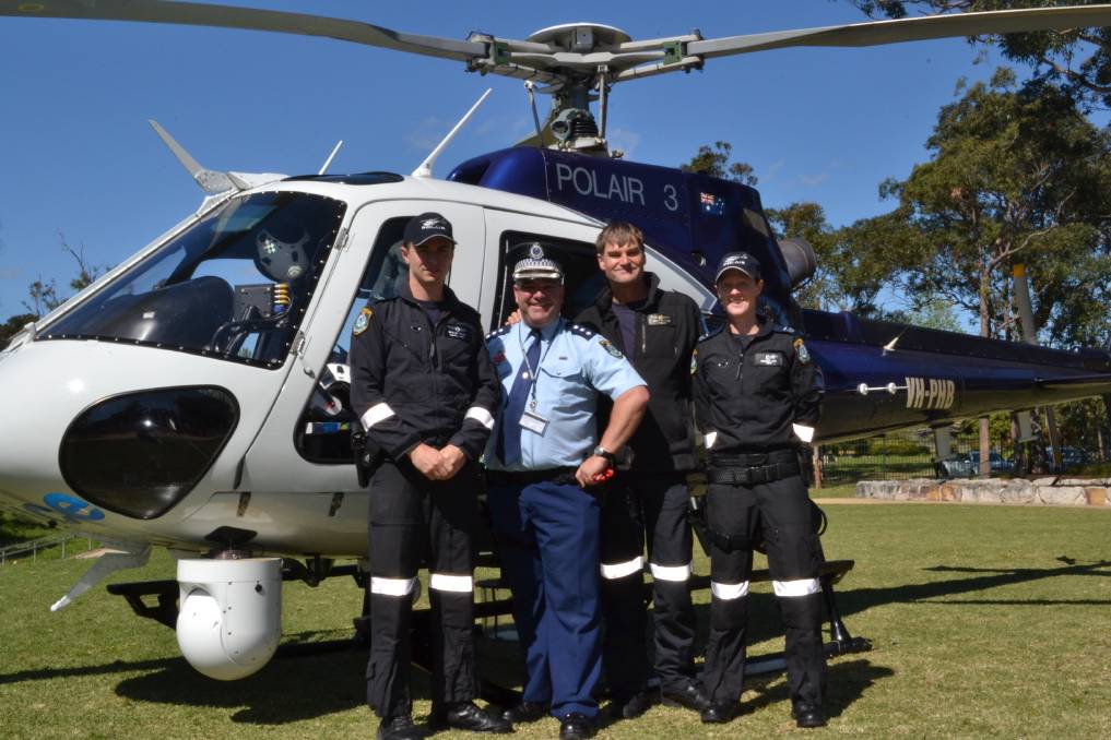 2013: POLAIR 3: Senior crew member John Smith, NSW Police Force Inspector Steve Johnson, pilot Allan Gary and assistant crew Kate Howe at the NSW Police Force open day at Nowra Anglican College on Saturday.