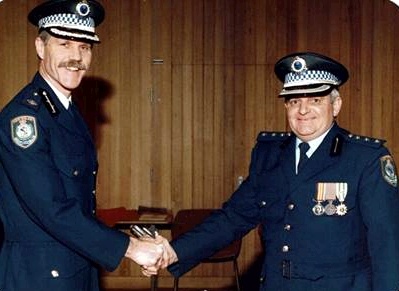 Geoffrey Alan HOLLIS receiving the 1st Clasp to the National Medal from Assistant Commissioner Jeff Jarrett in mid 1990's