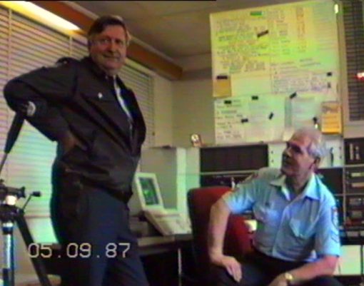 THESE PHOTOS ARE 'GRABBED' FROM VIDEO TAPE FROM 'VARIOUS 4' OF THE COLLECTION OF GREG CALLANDER.<br /> 1987 - 1988<br /> <br />Video transferred to DVD on 230206<br /> <br />SENIOR CONSTABLE <strong><a href="https://www.australianpolice.com.au/karl-hanson/" target="_blank" rel="noopener noreferrer">KARL HANSON</a></strong> # 8870  (SEATED), VKG2, WARILLA POLICE RADIO - SENIOR OPERATIONS OFFICER - SPEAKING WITH SENIOR SERGEANT <a href="https://www.australianpolice.com.au/richard-alan-brook/" target="_blank" rel="noopener noreferrer"><strong>DICK BROOK</strong></a> # 9570, FROM WARILLA POLICE STATION.<br /> <br /> 1987 - 1988