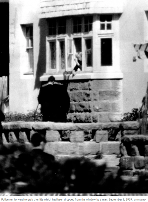 Police run forward to grab the rifle which had been dropped from the window by a man. September 9, 1969.Credit: Laurie Shea